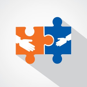 Businessman handshake with puzzle pieces